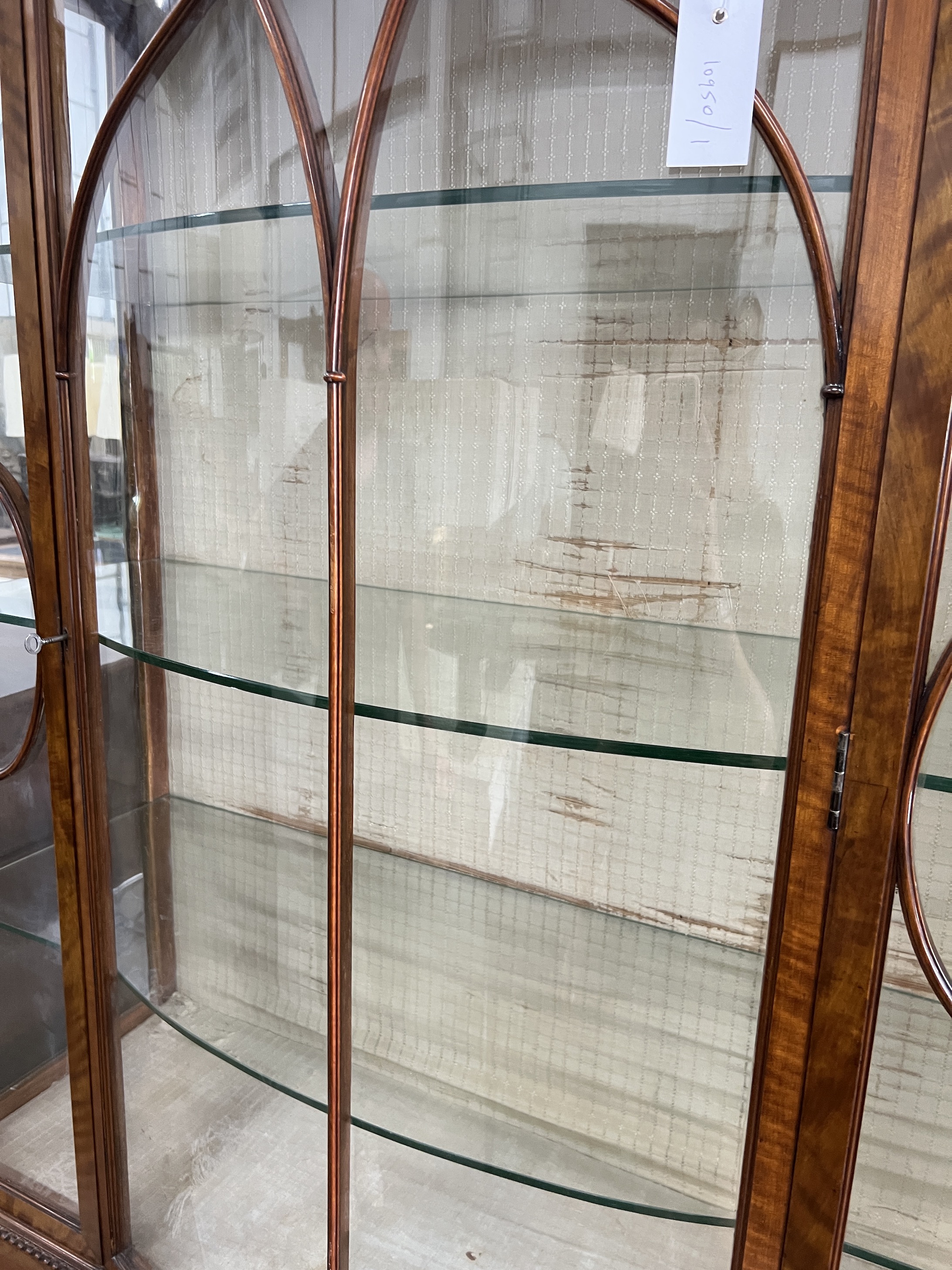 A 1920's Sheraton revival satinwood bowfront display cabinet, width 114cm, depth 42cm, height 211cm